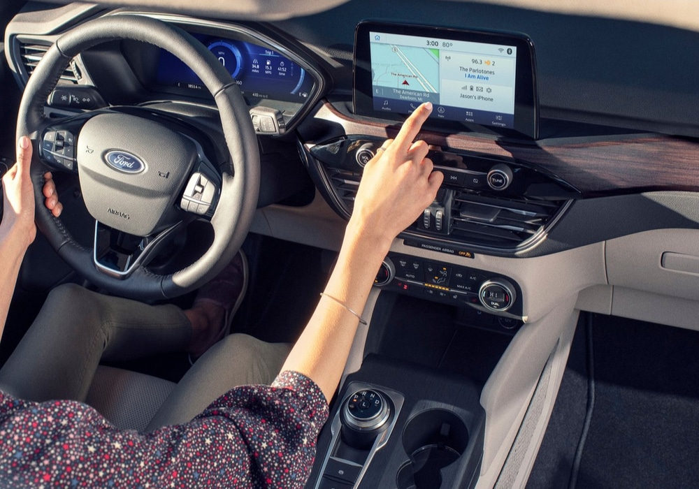 2020 Ford Escape interior driver interacting with touchscreen display
