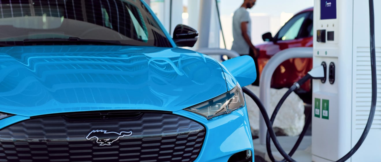 A Ford Mustang Mach-E charging at a Ford charging station.