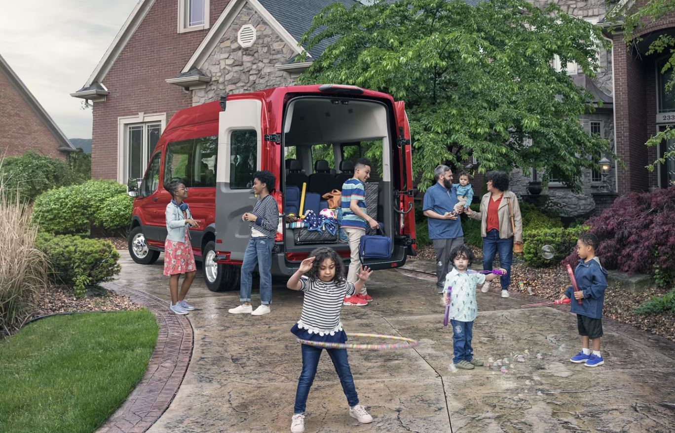 A large family utilizing the space inside a Ford Transit.