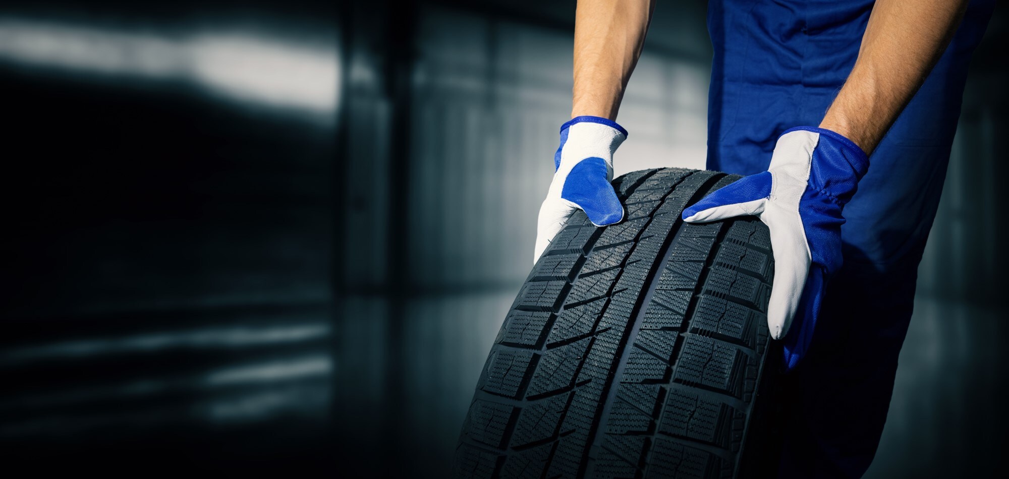 A closeup of a person's hands holding a car tire