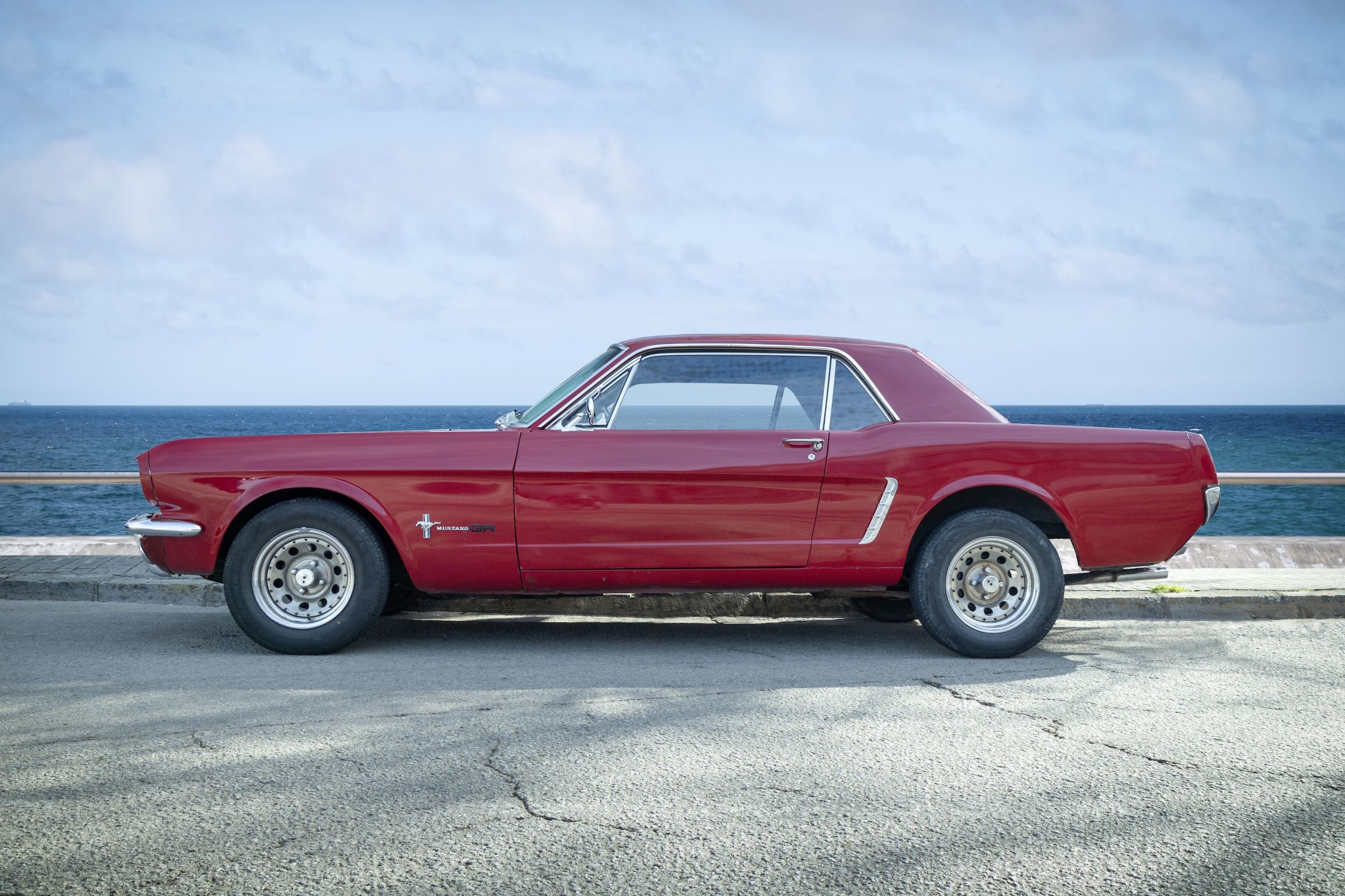A first generation red Ford Mustang.