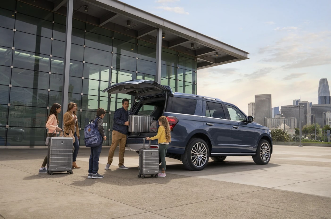 A Ford Expedition with a family getting into it.