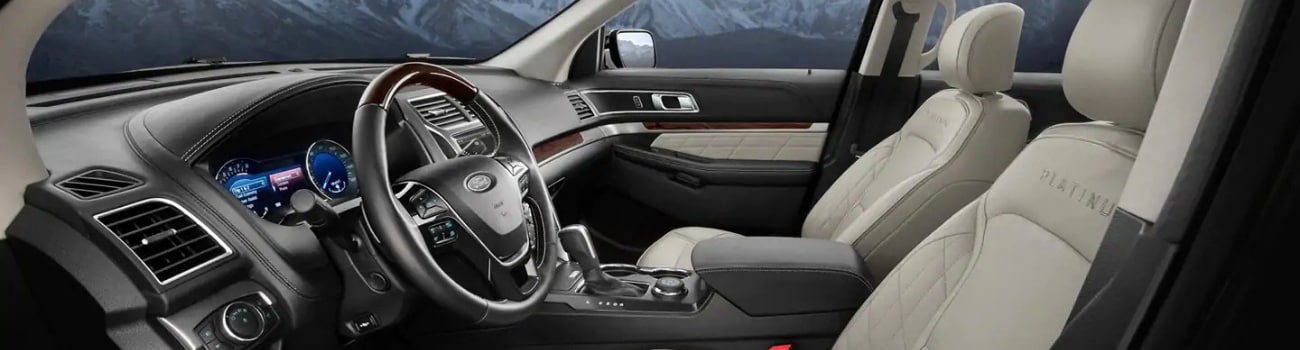 Interior of a 2019 Ford Explorer from the driver side door showing the steering wheel, dashboard, and elegant seat design