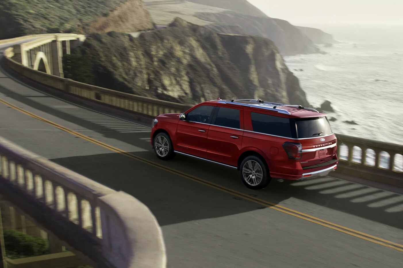 A red 2023 Ford Expedition takes a winding highway