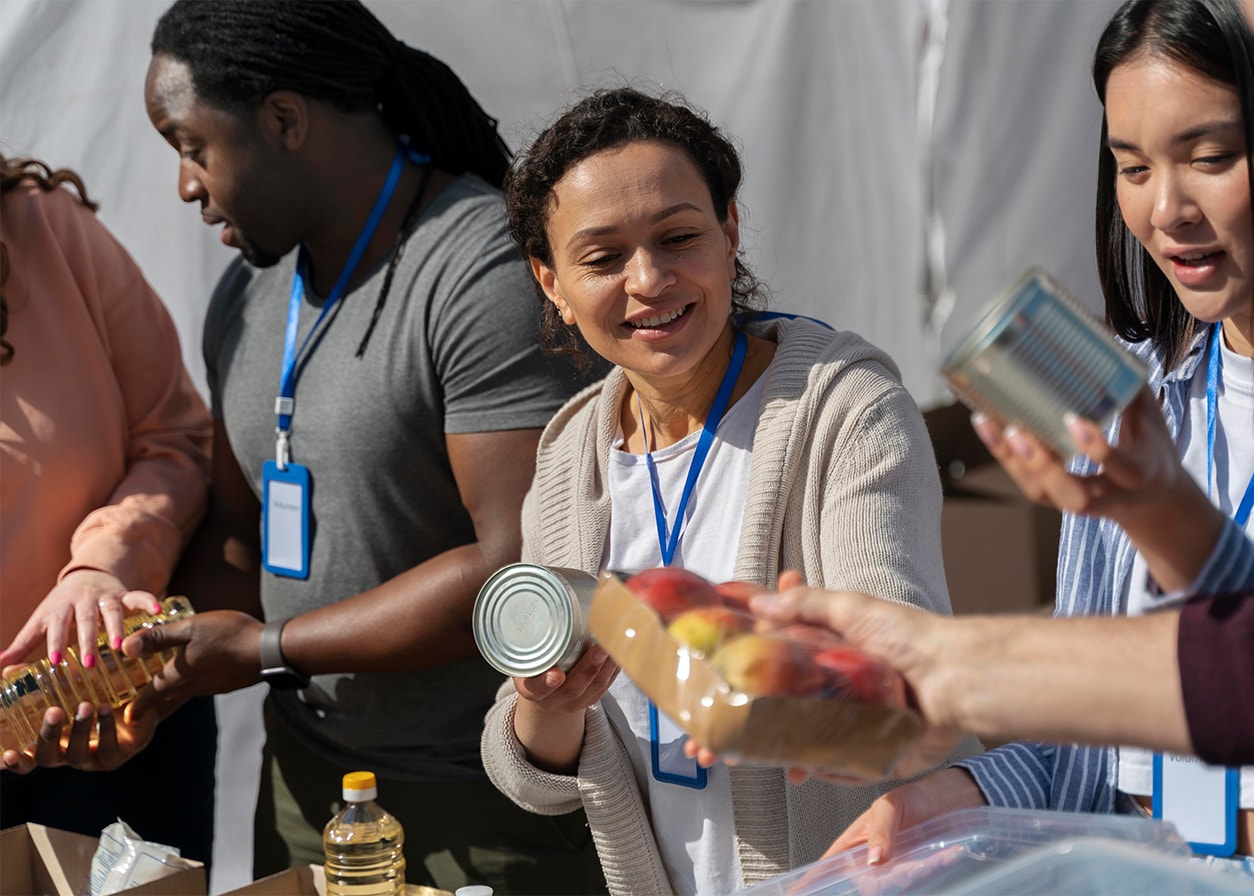 Volunteers helping hand out food at a charity
