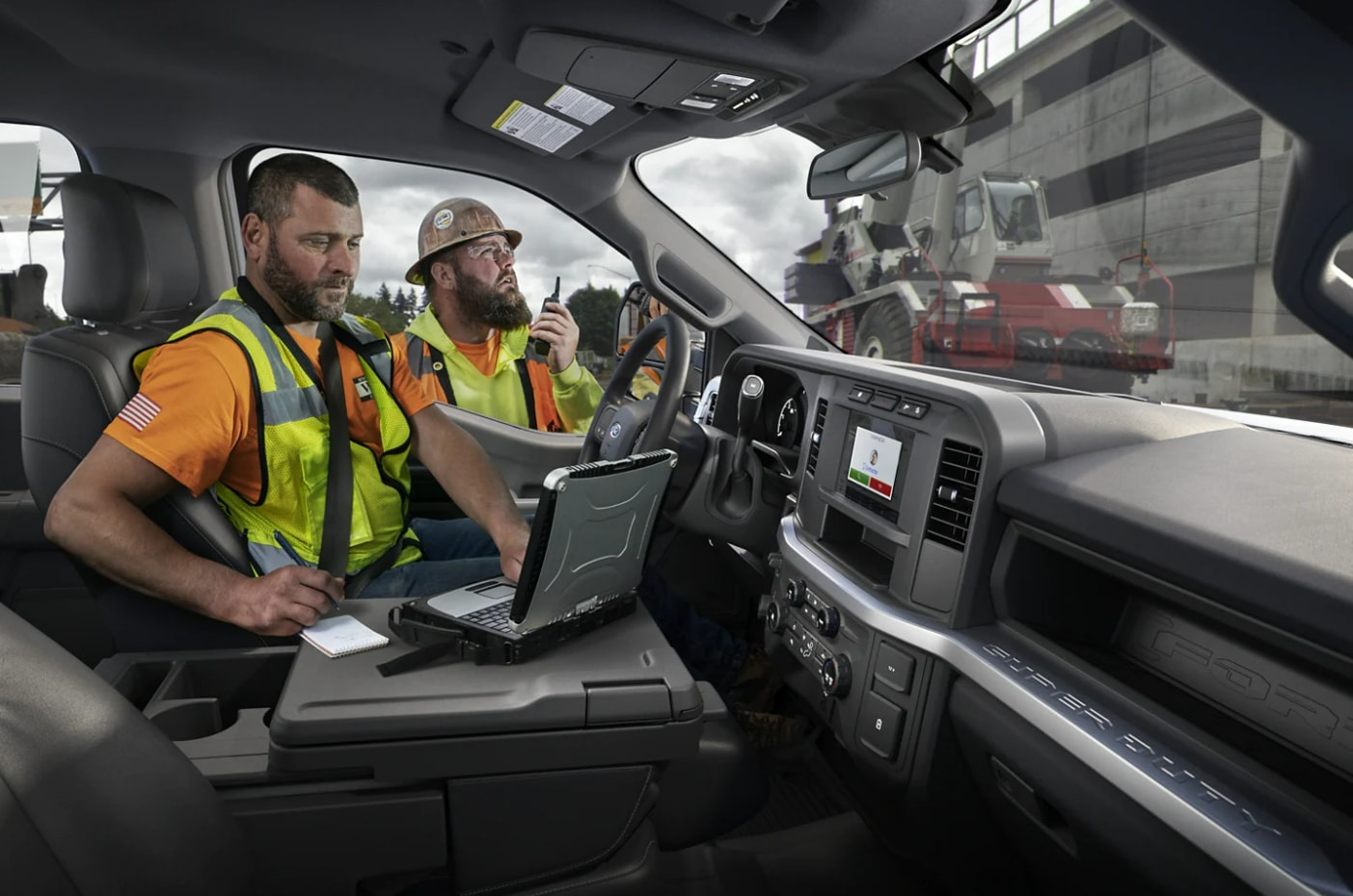 A construction worker arriving at a job site while getting ready inside the new Ford Super Duty. 