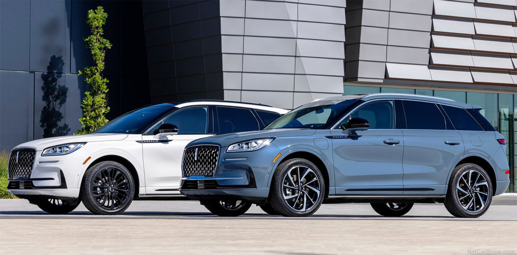 Two Lincoln Corsair's parked next to each other in a city street.