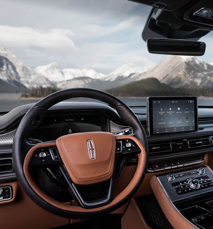 The interior of a Lincoln Vehicle with a snowy backdrop behind it.