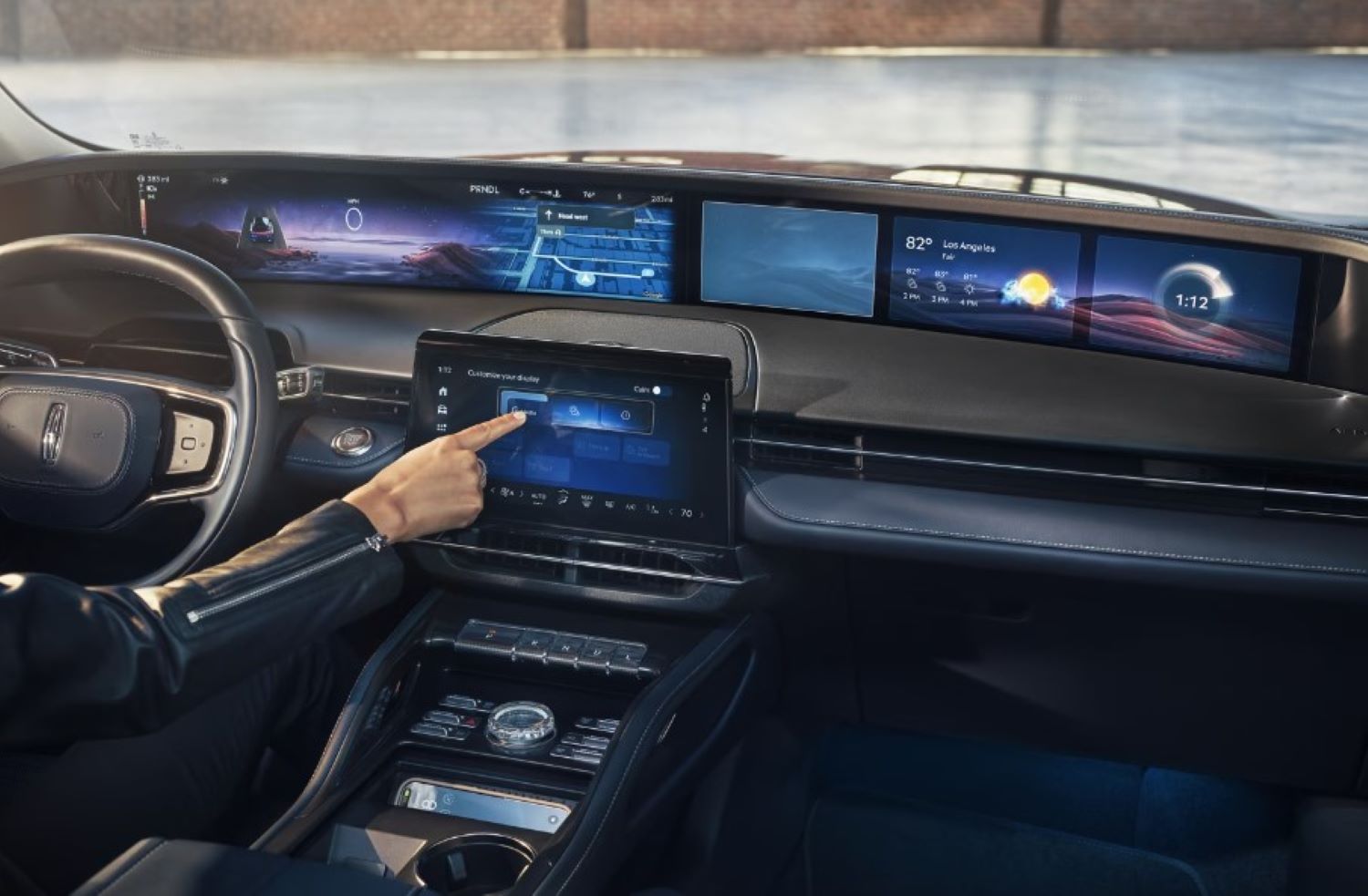 The control center of the Lincoln Nautilus being utilized by a driver.
