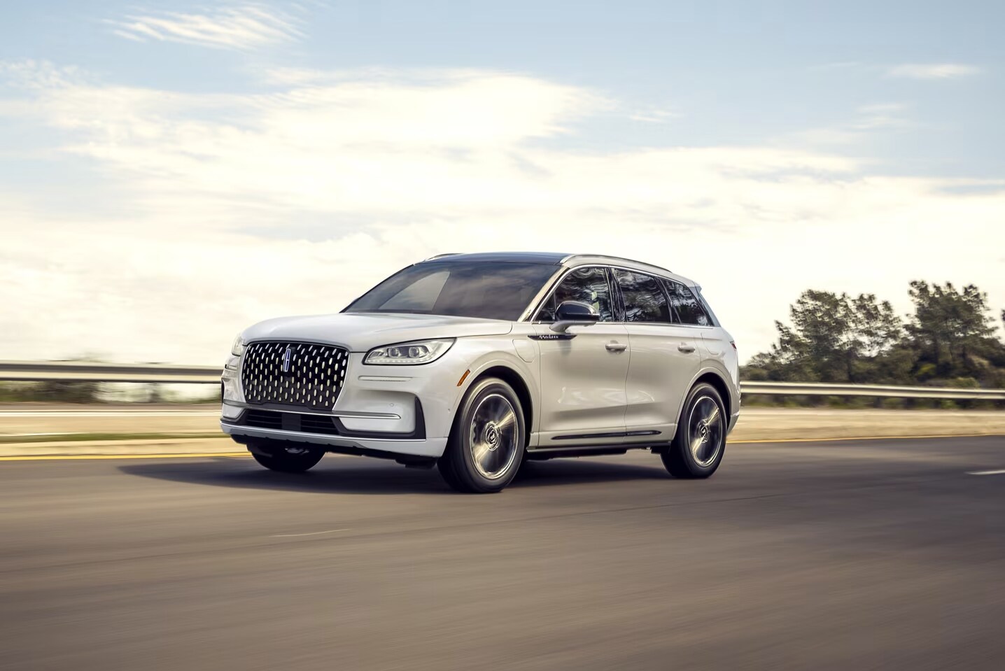 A 2025 Lincoln Corsair driving down a road.