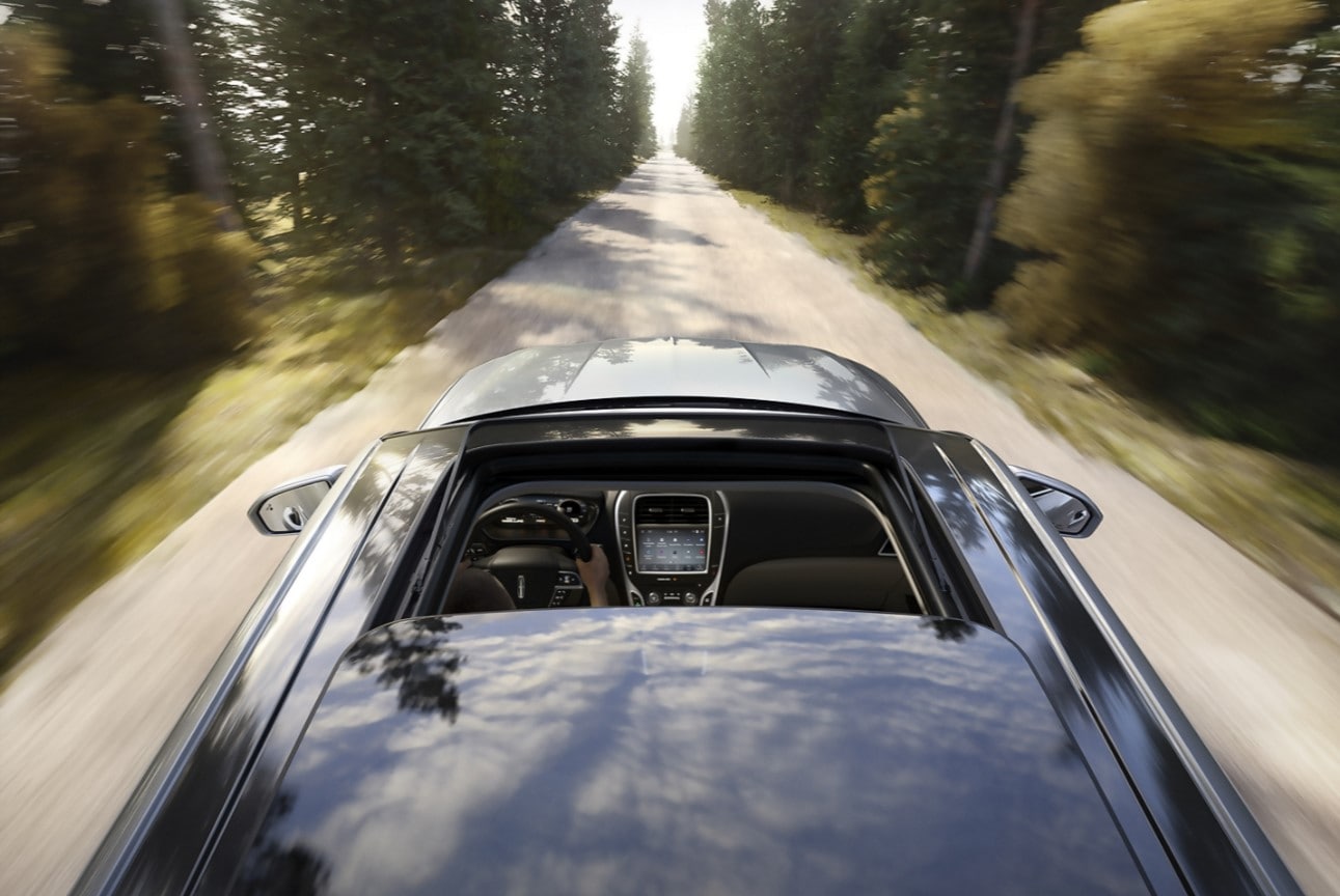 Top view of a 2021 Lincoln Nautilus driving on a forest road