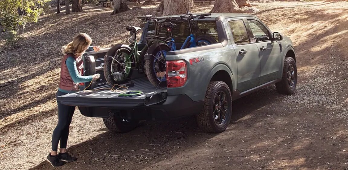 woman-loading-bicycles-into-truck-bed-of-2023-ford-maverick