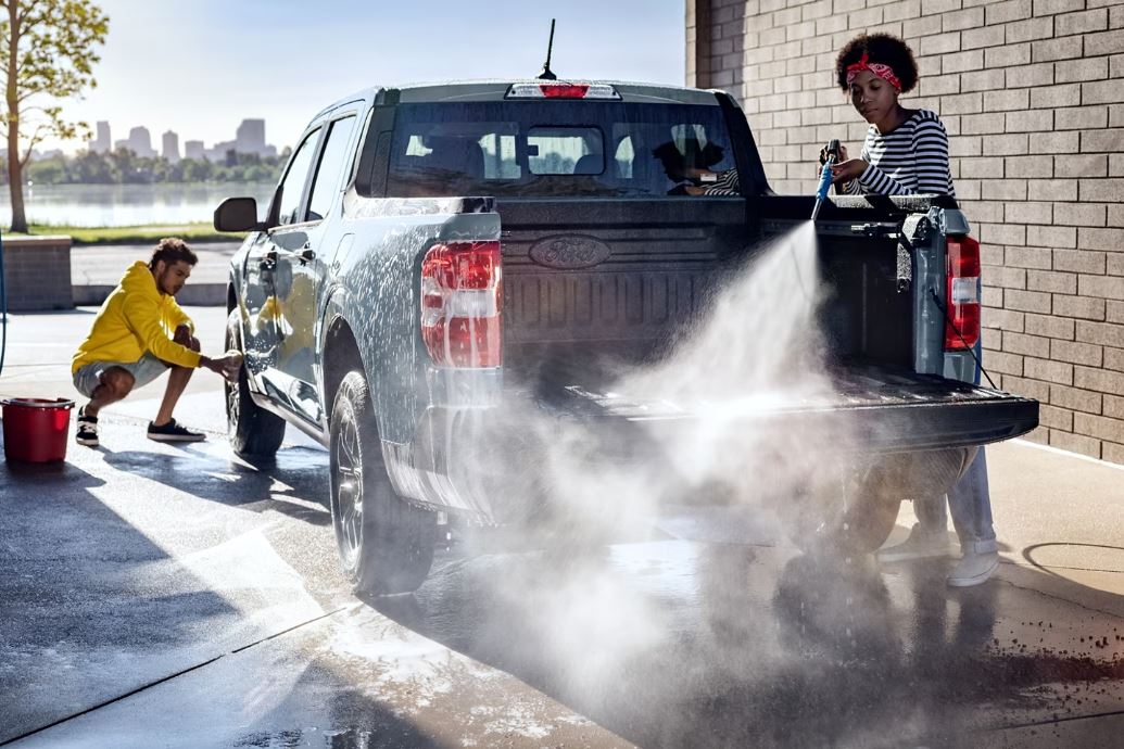 A Ford Maverick being cleaned at a car wash.