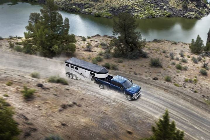 The-Ford-Super-Duty-displayed-with-mountains-behind-them.