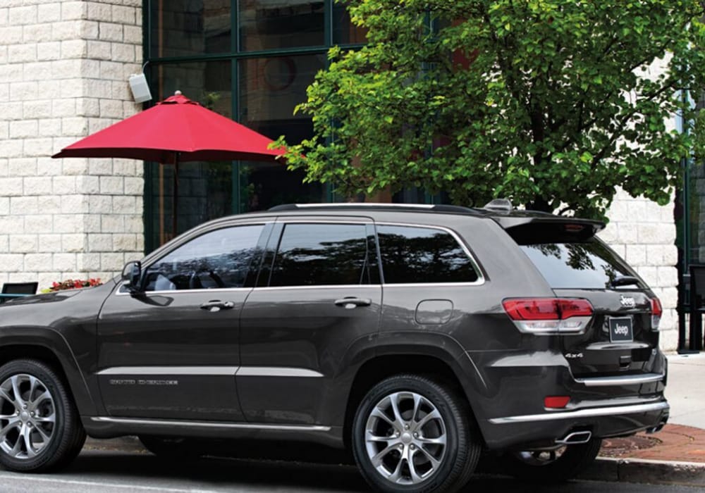 2020 Jeep Grand Cherokee rear exterior design view parked outside a downtown government building