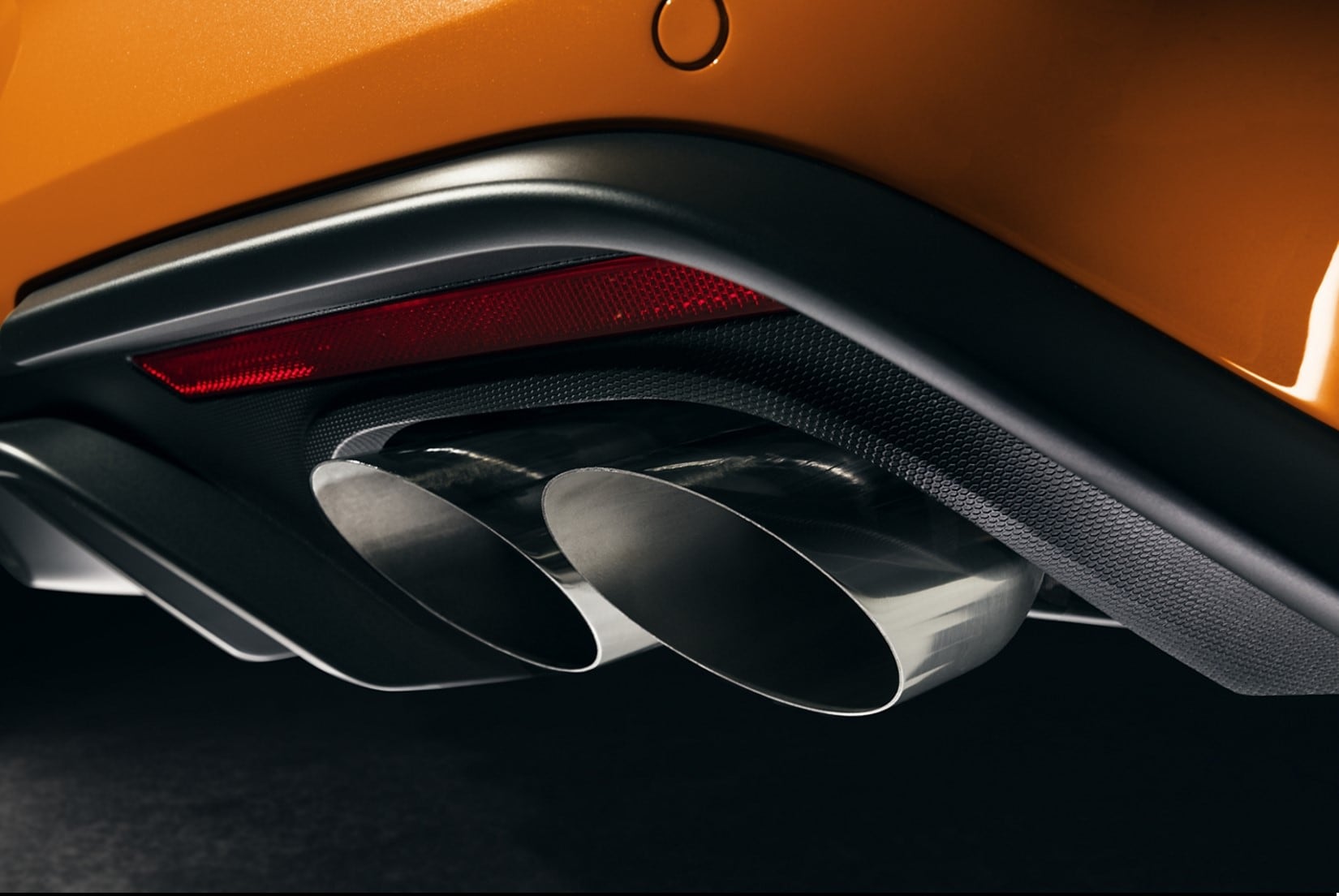 close up view of the bumper and dual exhaust pipes of a 2020 Ford Mustang