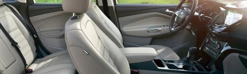 Interior of a 2019 Ford Escape showing a sleek cream color interior trim highlighting the infotainment system on the front dashboard