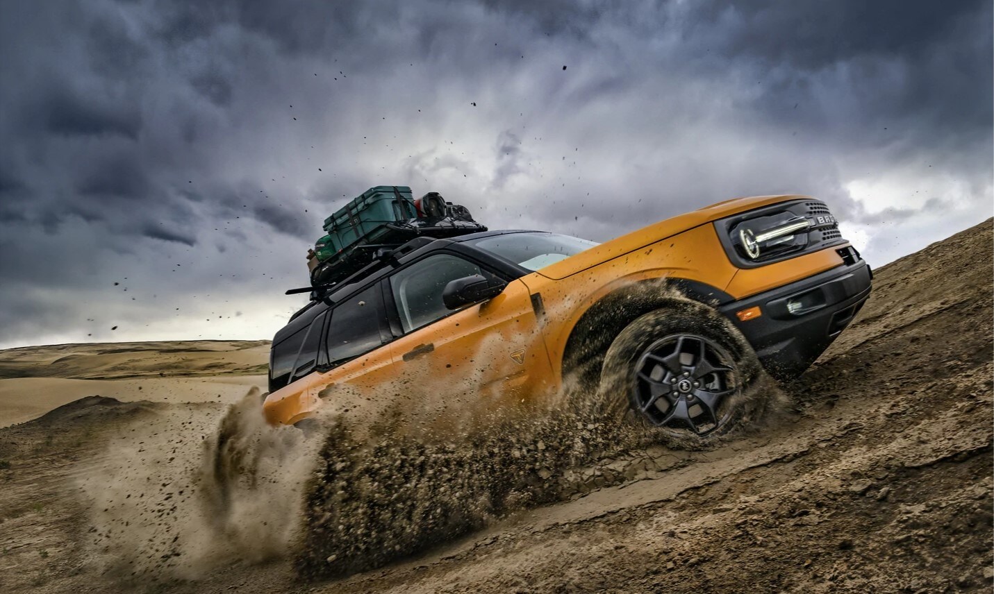 2021 Ford Bronco Sport powerfully driving up sand dunes