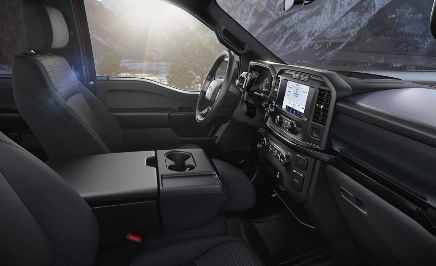 Front interior seating and dashboard inside the 2021 Ford F-150 XLT SuperCab truck