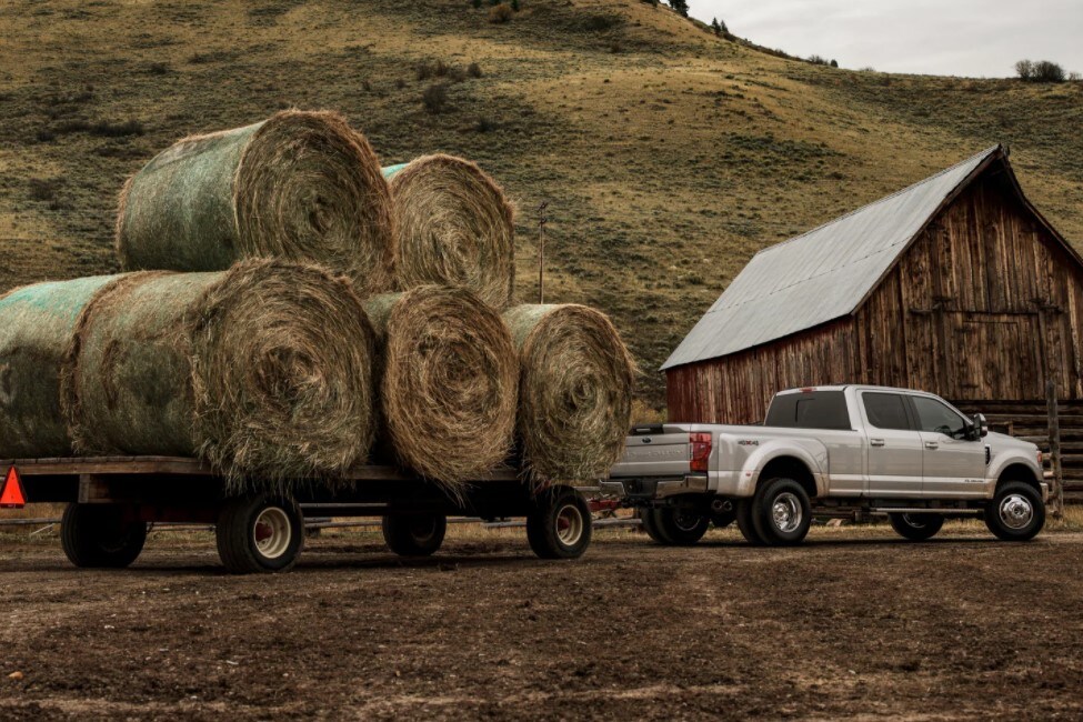 A 2021 Ford Super Duty towing hay