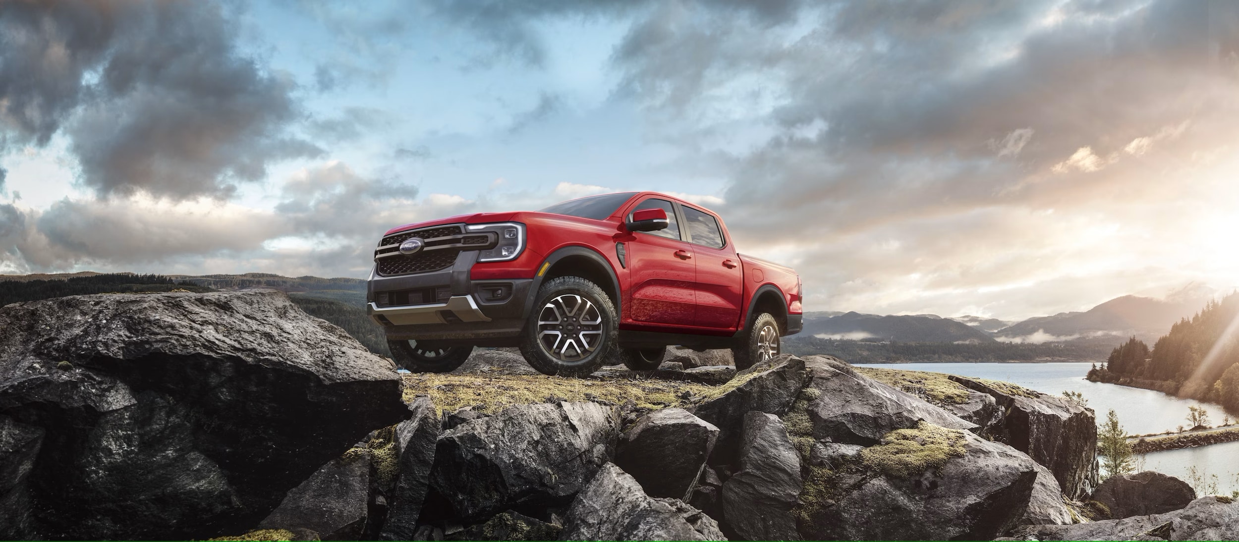 Red Ford Ranger parked on a rocky hill.