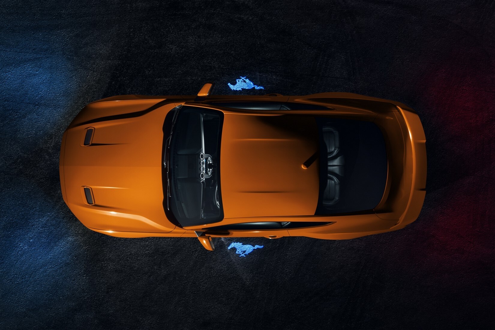 aerial view of the exterior shape and design of an orange 2020 Ford Mustang