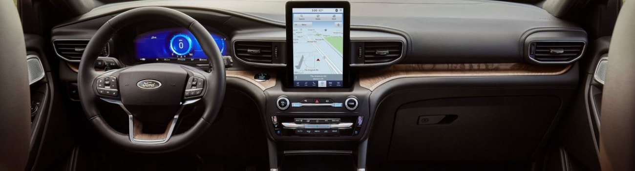 Interior view of the front cabin in a 2020 Ford Explorer from the back seat showing the redesigned dashboard and infotainment system