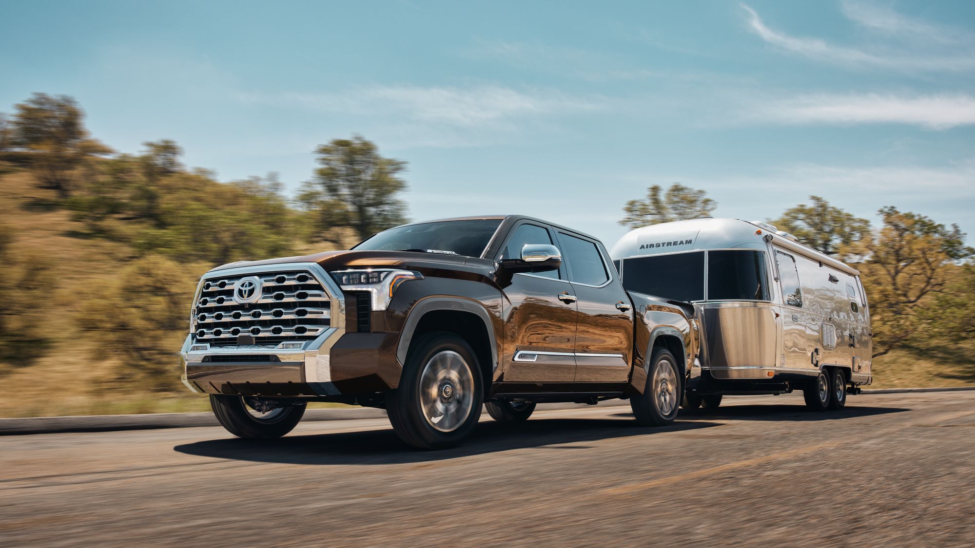 A 2024 Toyota Tundra pulling a camper behind it.