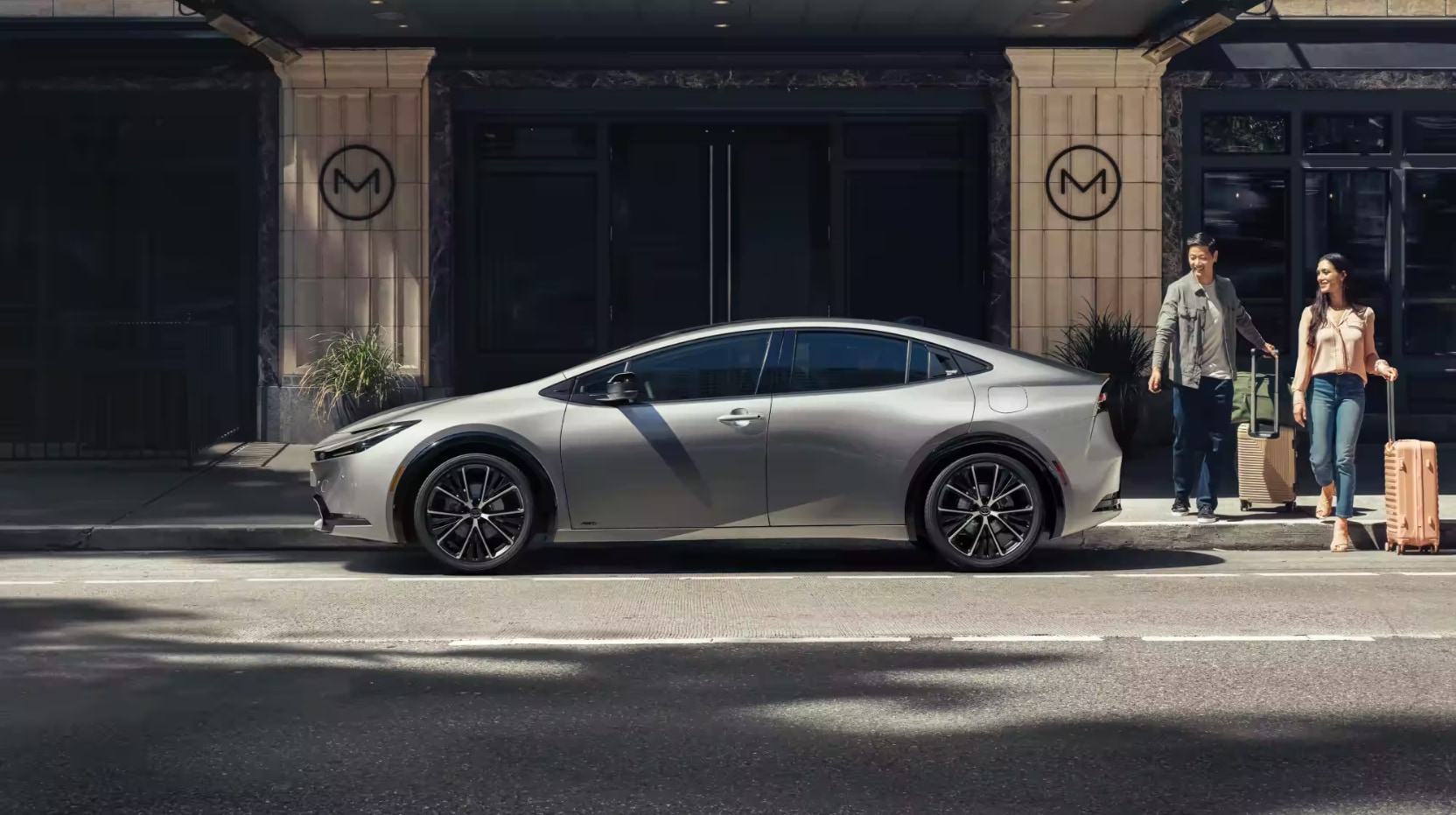 A profile view of a parked silver 2023 Toyota Prius