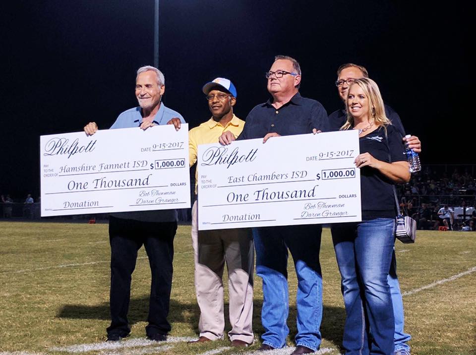 Philpott presents checks to Hamshire Fannett ISD and East Chambers ISD