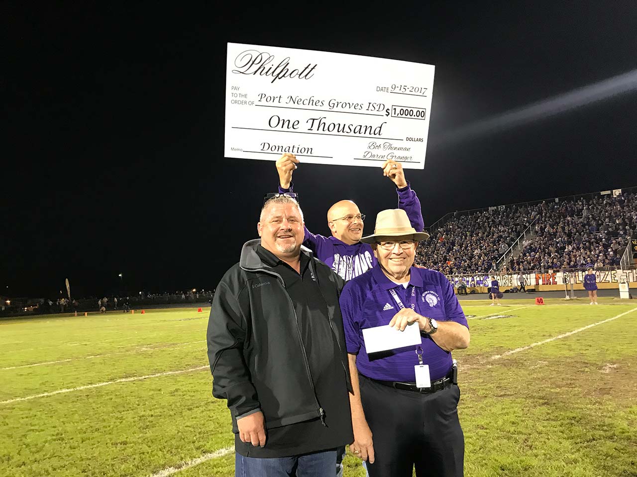 Philpott presents a check to Port Neches-Groves ISD