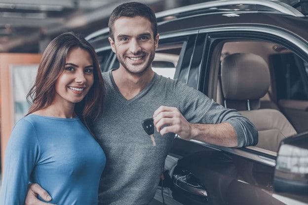 Couple- holding-keys-to-new-car.jpg