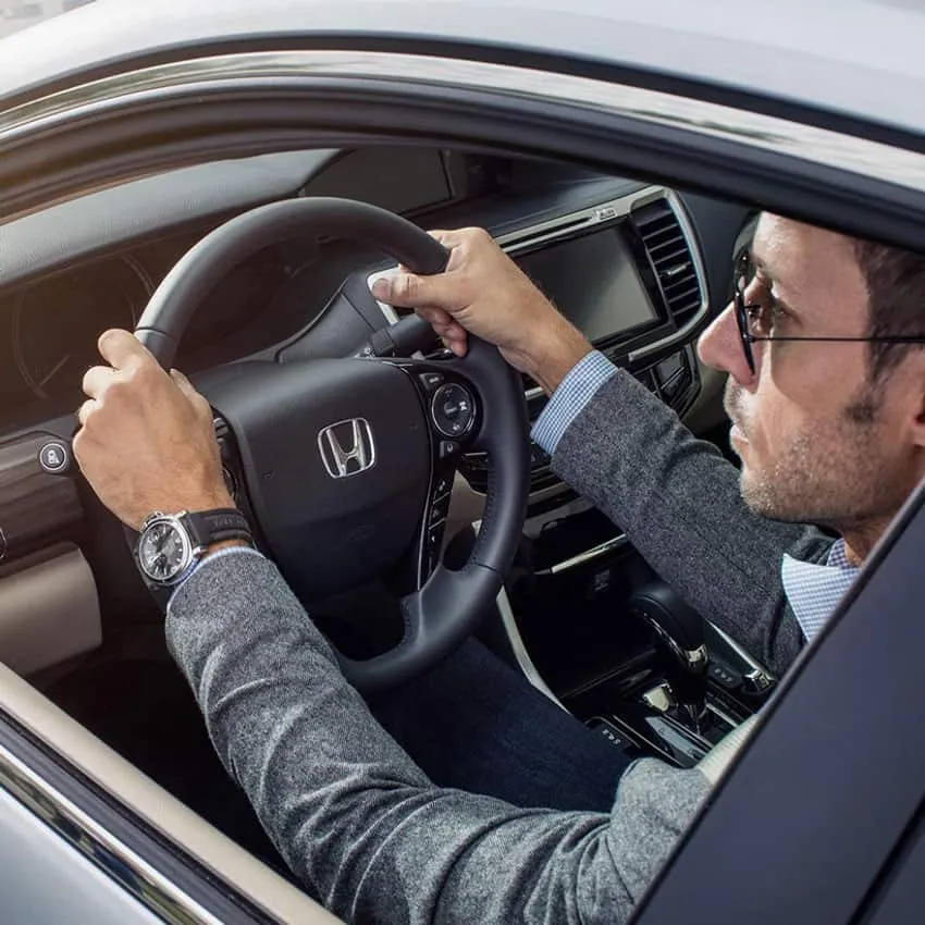 man driving honda dashboard center console visible a/c knobs