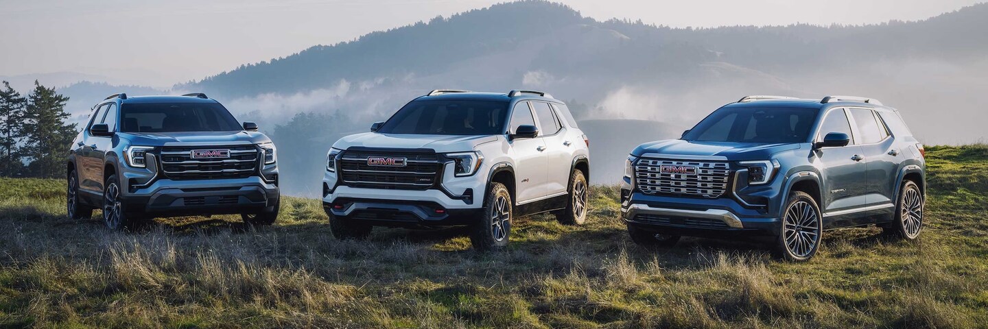  three 2026 gmc terrains lined up on a mountainside