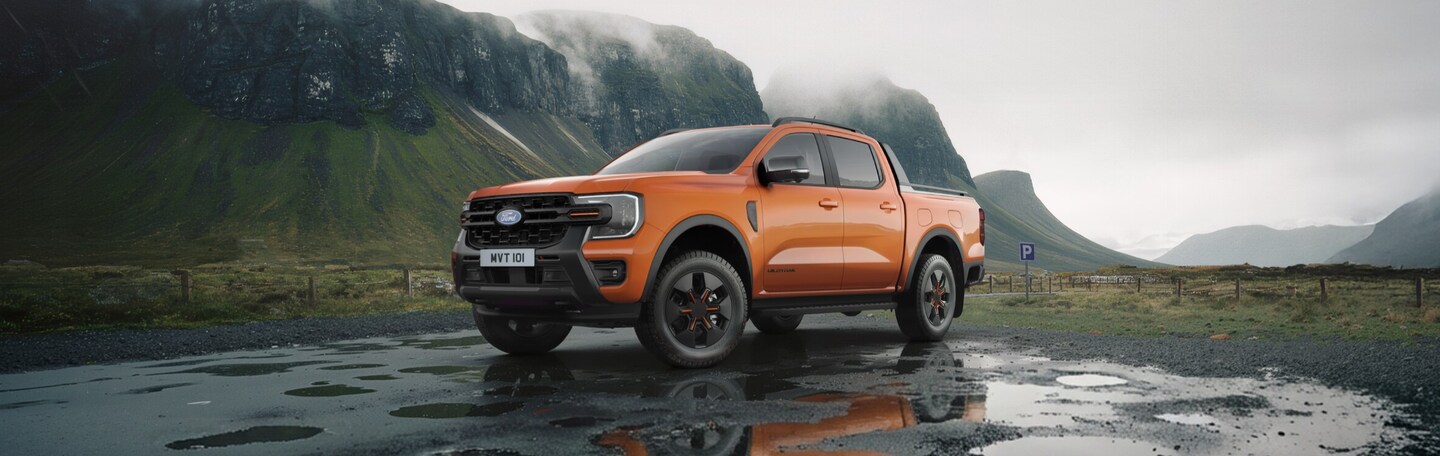  orange 2026 ford ranger phev, international, on a wet cliff