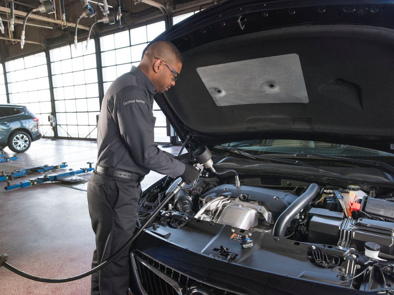 Buick Service Buick Service staff performing an oil change to a Buick vehicle