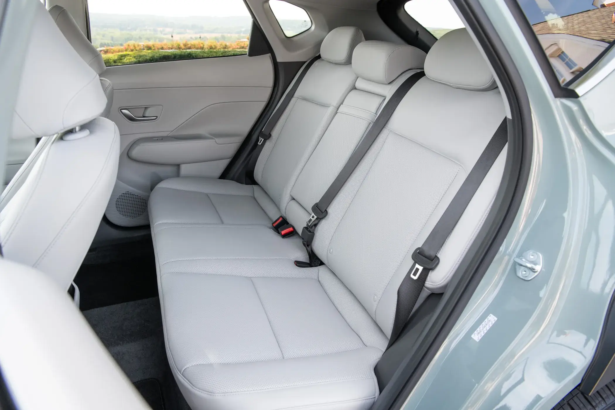 Rear bench seat of a Hyundai Kona with headrests and rear door panels visible