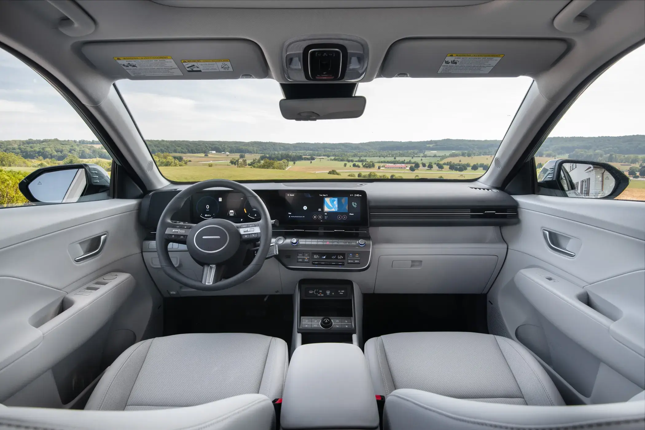 Hyundai Kona dashboard with dual wide screens, center vents and console-mounted controls