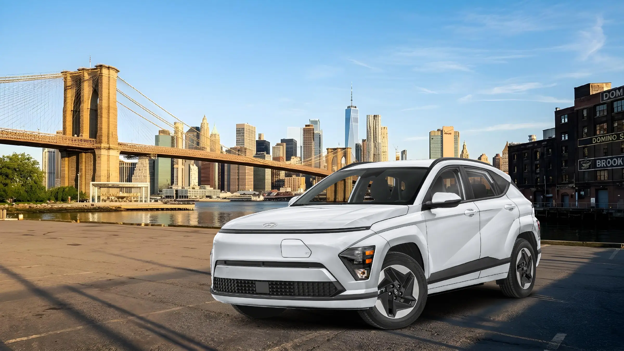 Hyundai Kona parked with the Brooklyn Bridge and the East River behind it