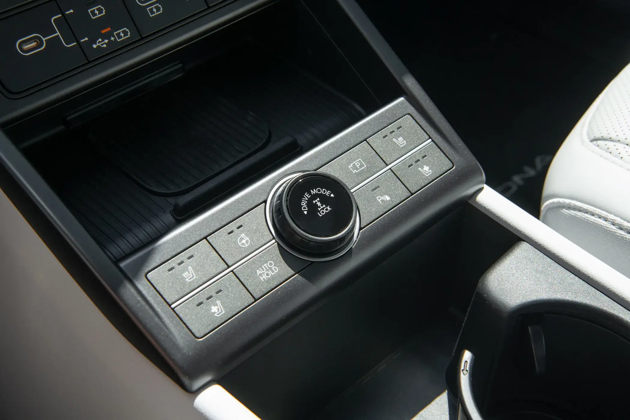 Center console control panel of a Hyundai Kona with USB-C ports and heated seat and climate buttons