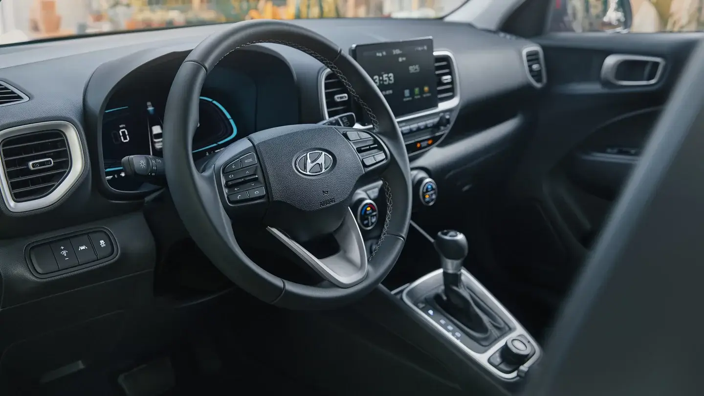 Hyundai Venue black cloth interior viewed from the driver side showing dashboard and console