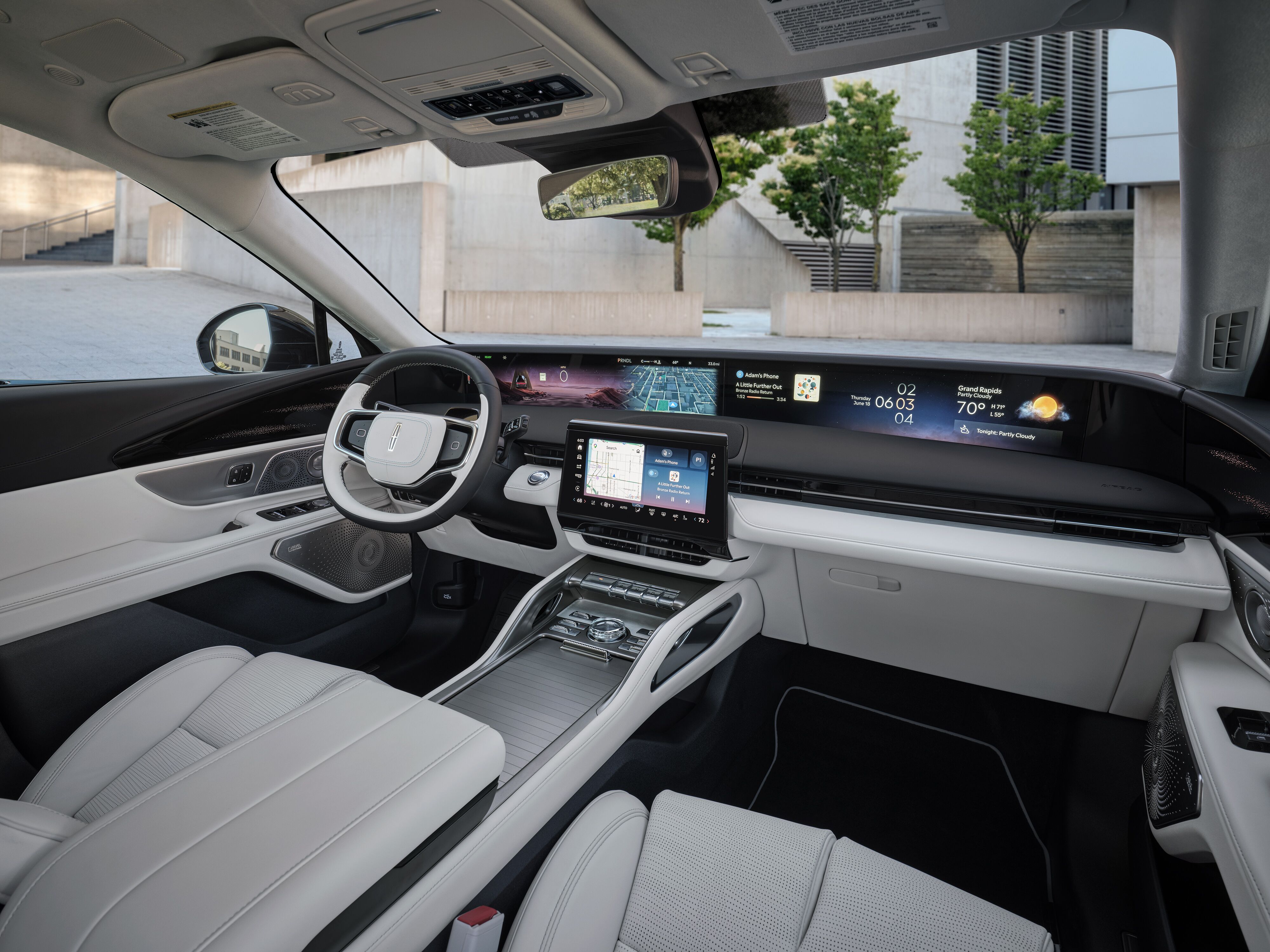 2027 Lincoln Nautilus interior cabin featuring white leather seats, flat-top steering wheel, and full-width panoramic dashboard display.