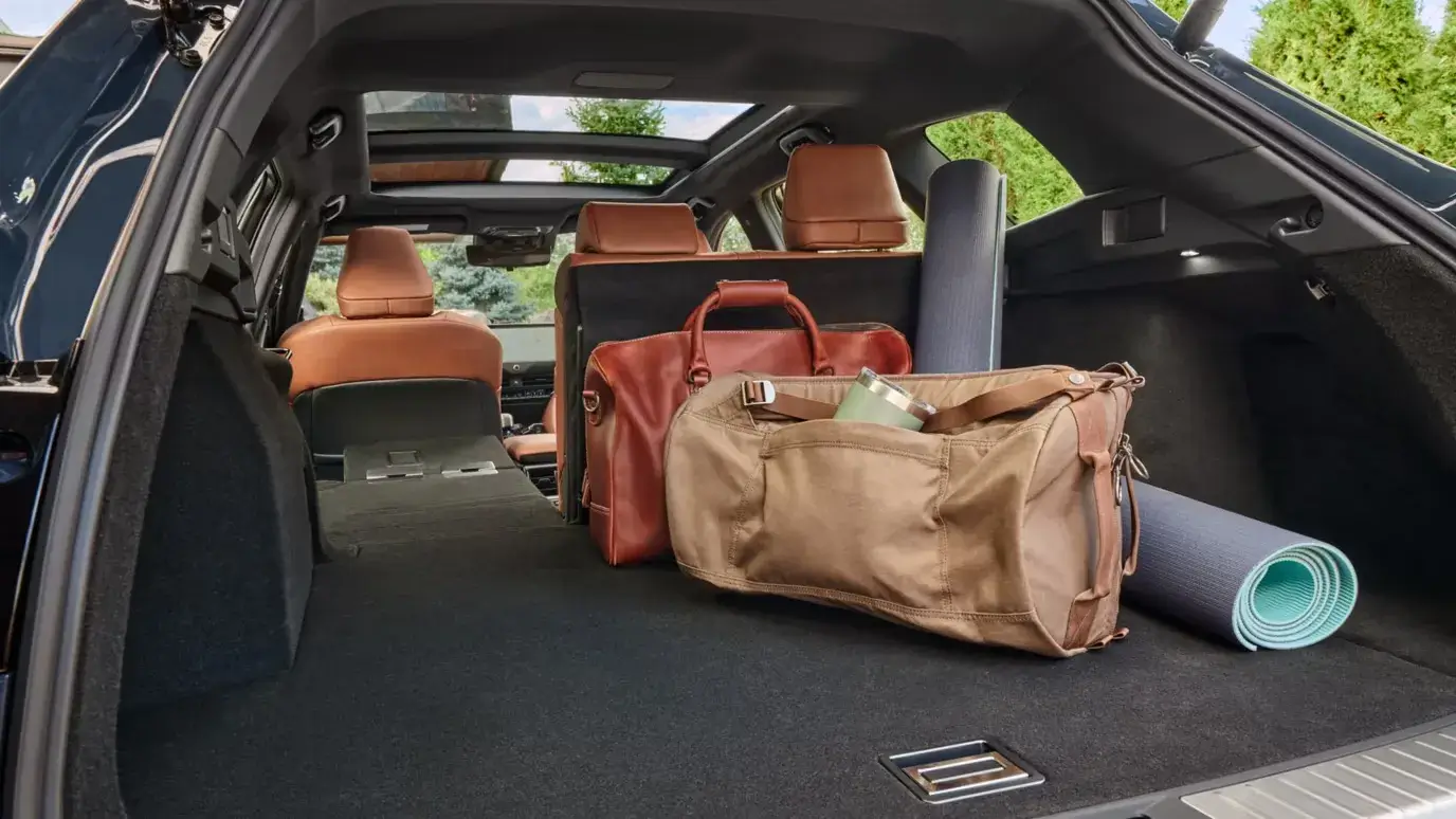 Toyota Crown Signia cargo area with one section of the rear seat folded to extend the load floor