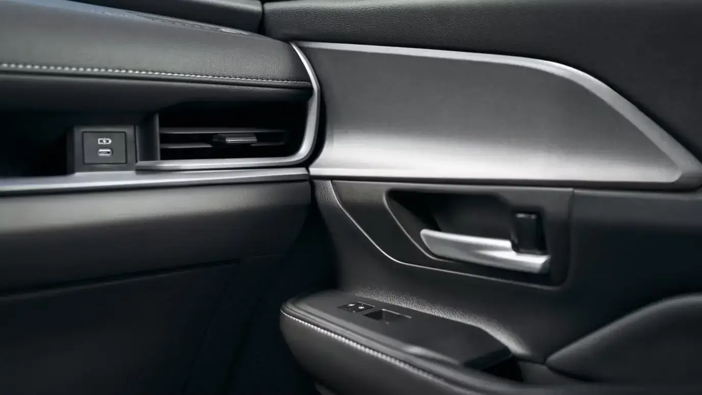 Hybrid Nightshade interior in black leather trim showing the front passenger door handle and surrounding detail