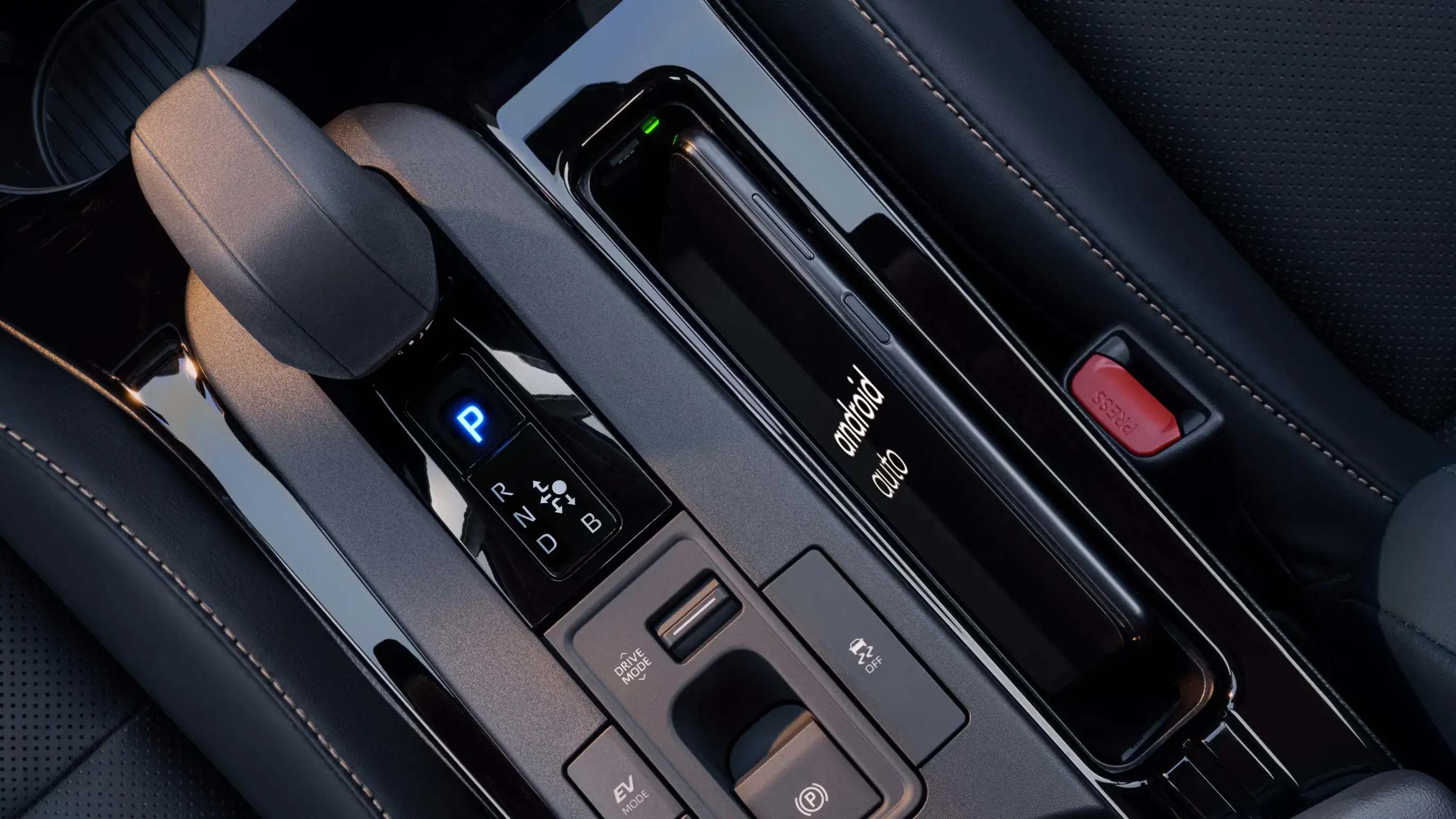 Toyota Prius center console showing the compact shifter, drive mode controls and storage