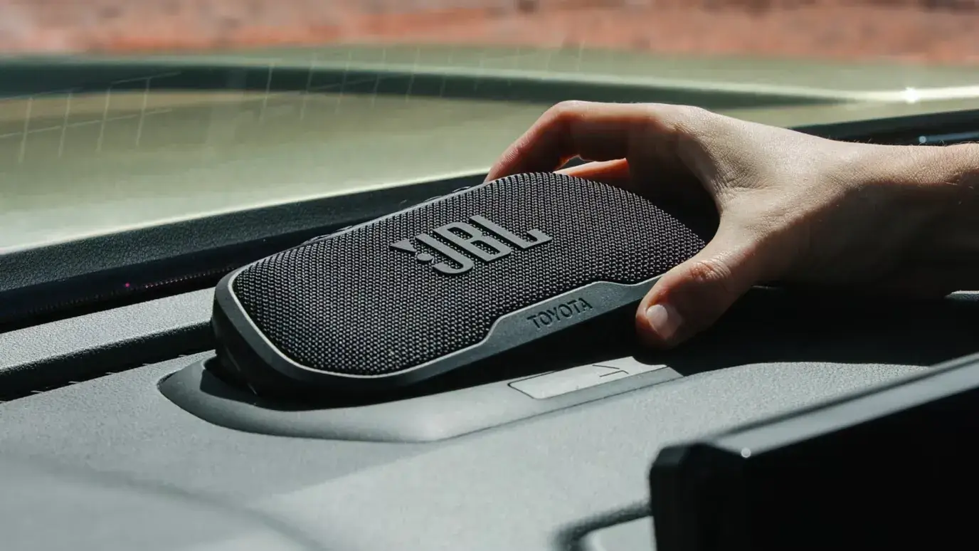 Removable JBL portable Bluetooth speaker docked in the Toyota Tacoma dashboard