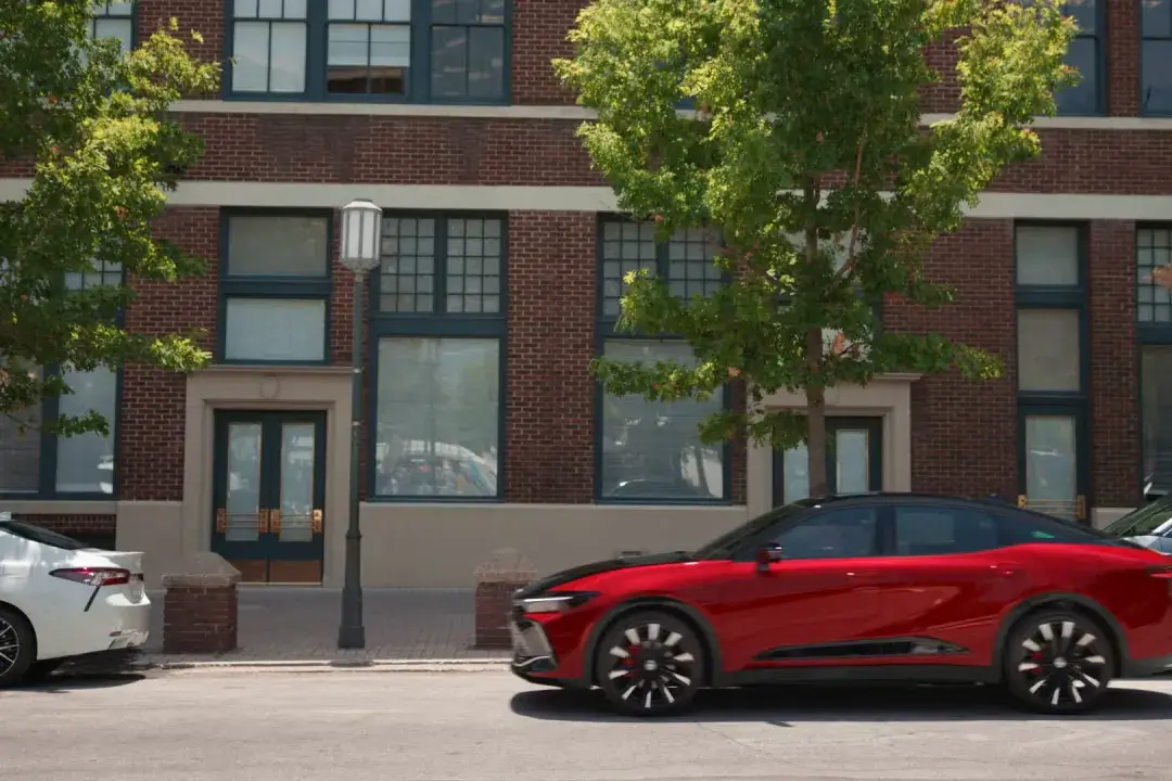 Toyota Crown using Advanced Park hands-free parking assist to parallel park, shown from the driver side