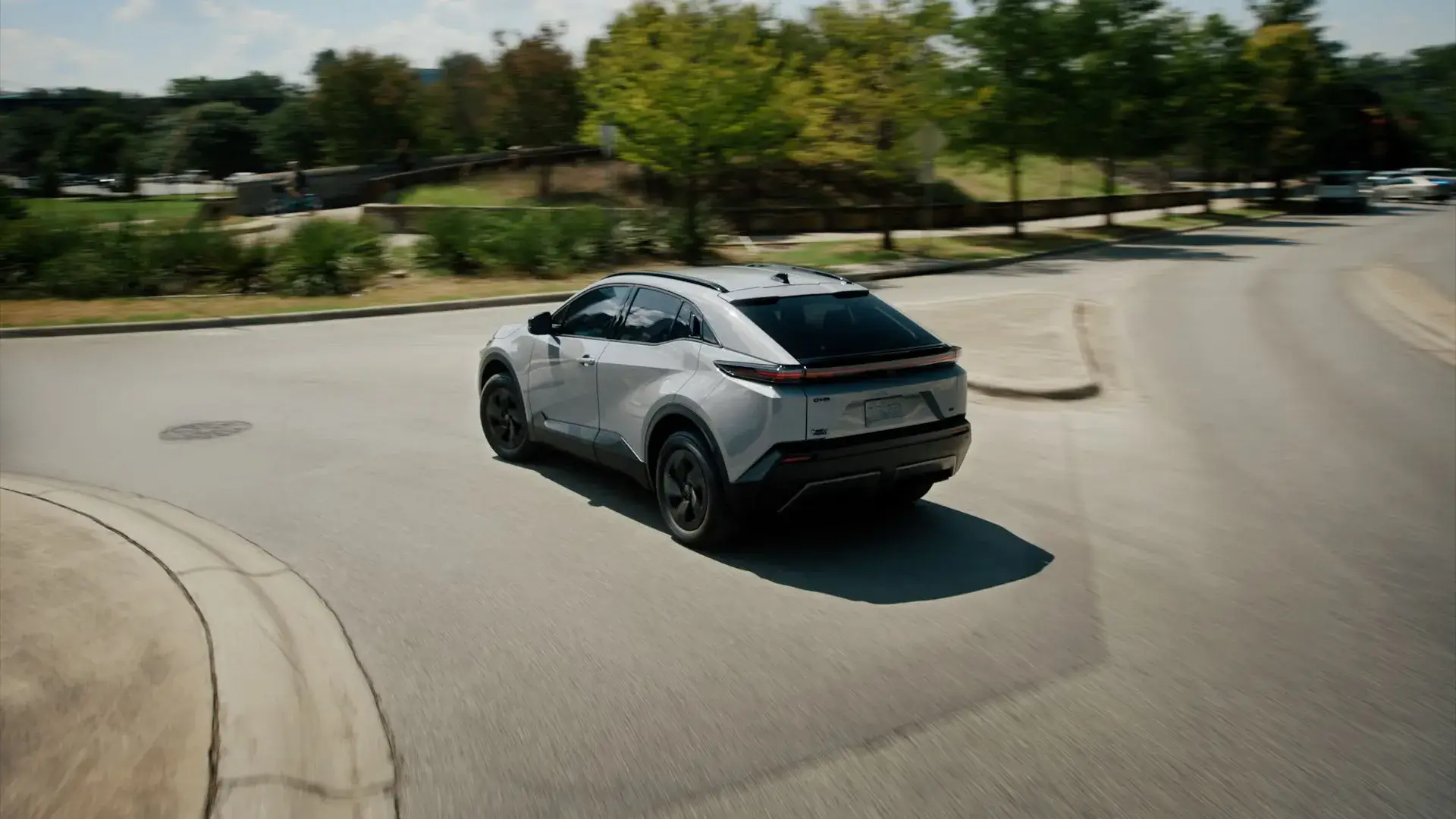 Rear three-quarter view of the Toyota C-HR all-electric SUV with dual-motor all-wheel drive