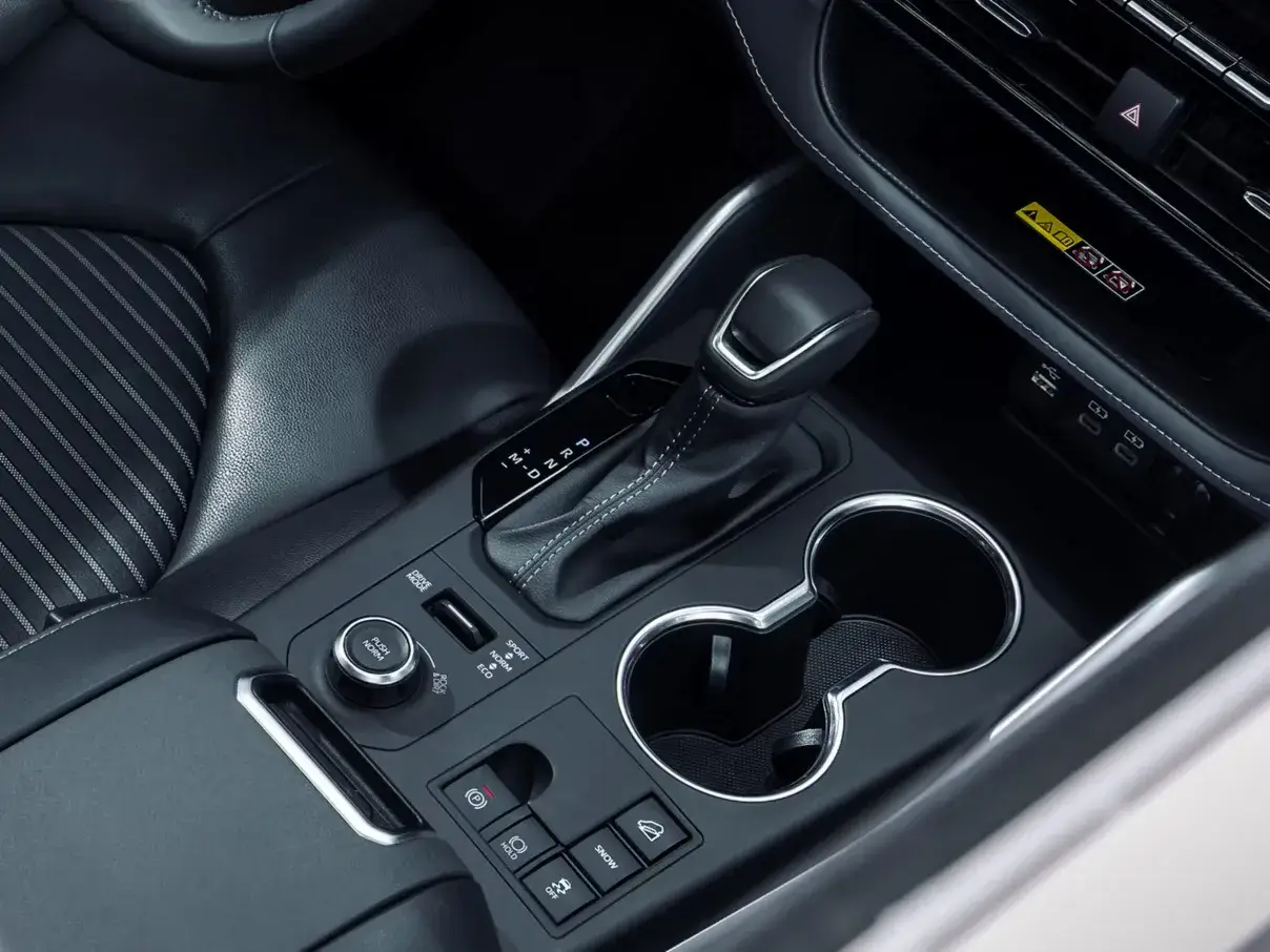 Toyota Highlander center console with cup holders and shifter surround, shown on a previous-generation model