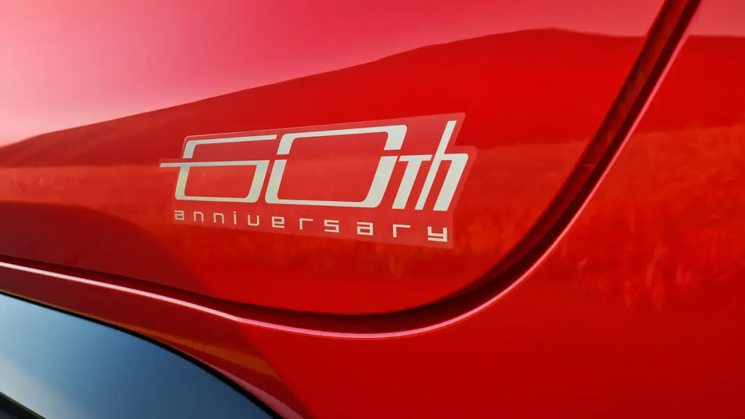 2027 Toyota Corolla Hybrid 60th Anniversary Special Edition in Supersonic Red with black-finished alloy wheels